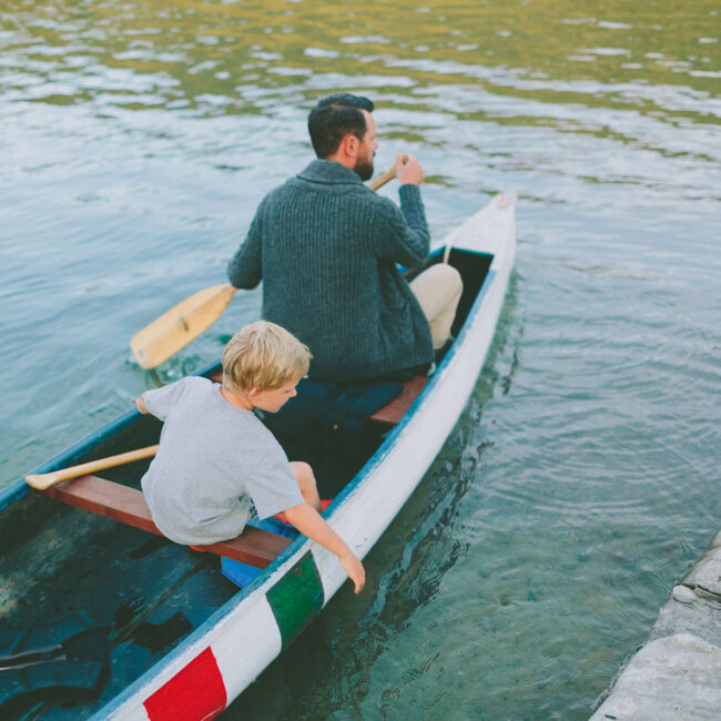 a-father-and-son-taking-a-canoe-out-on-the-lake-in-2022-11-15-22-34-54-utc