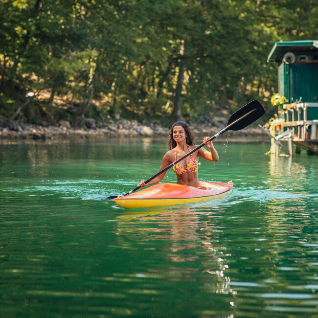young-woman-canoeing-in-a-lake-on-a-summer-day-2023-02-15-20-34-52-utc